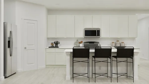 a kitchen with a stove and white cabinets