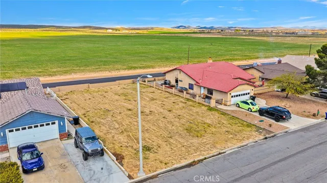 an aerial view of a house with pool lake view and mountain view