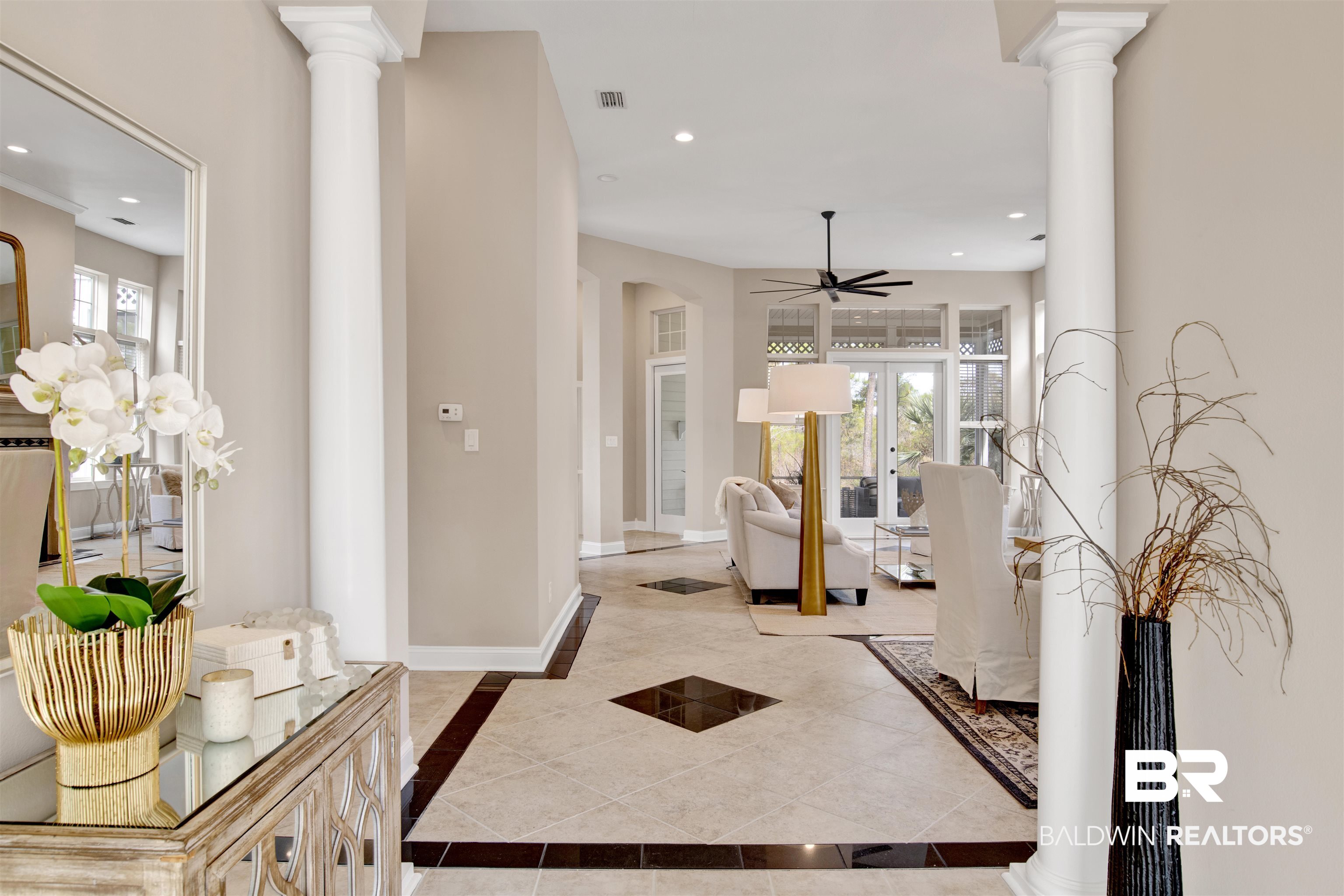9259 Genipa Way Gulf Shores, AL 36542 - Photo 9 of 72 Hallway featuring light tile patterned floors, decorative columns, and french doors