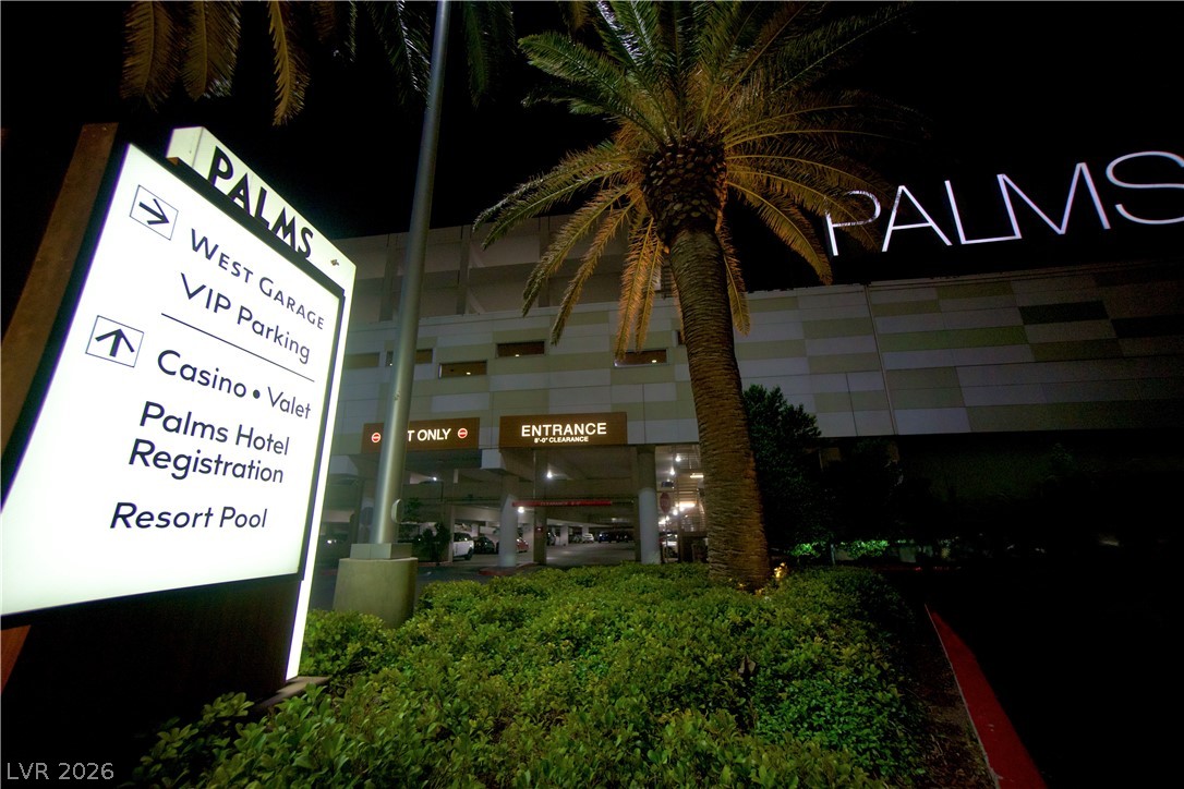 4381 West Flamingo Road, Unit 3616 Las Vegas, NV 89103 - Photo 26 of 29 Illuminated signage directs visitors to the West Garage, VIP Parking, Casino, Valet, Palms Hotel Registration, and Resort Pool, set against a backdrop of lush foliage and a prominent palm tree.