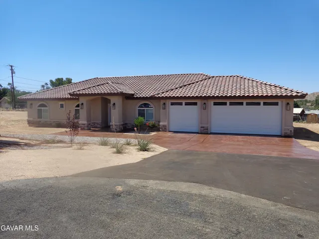 a front view of a house with a basket ball court