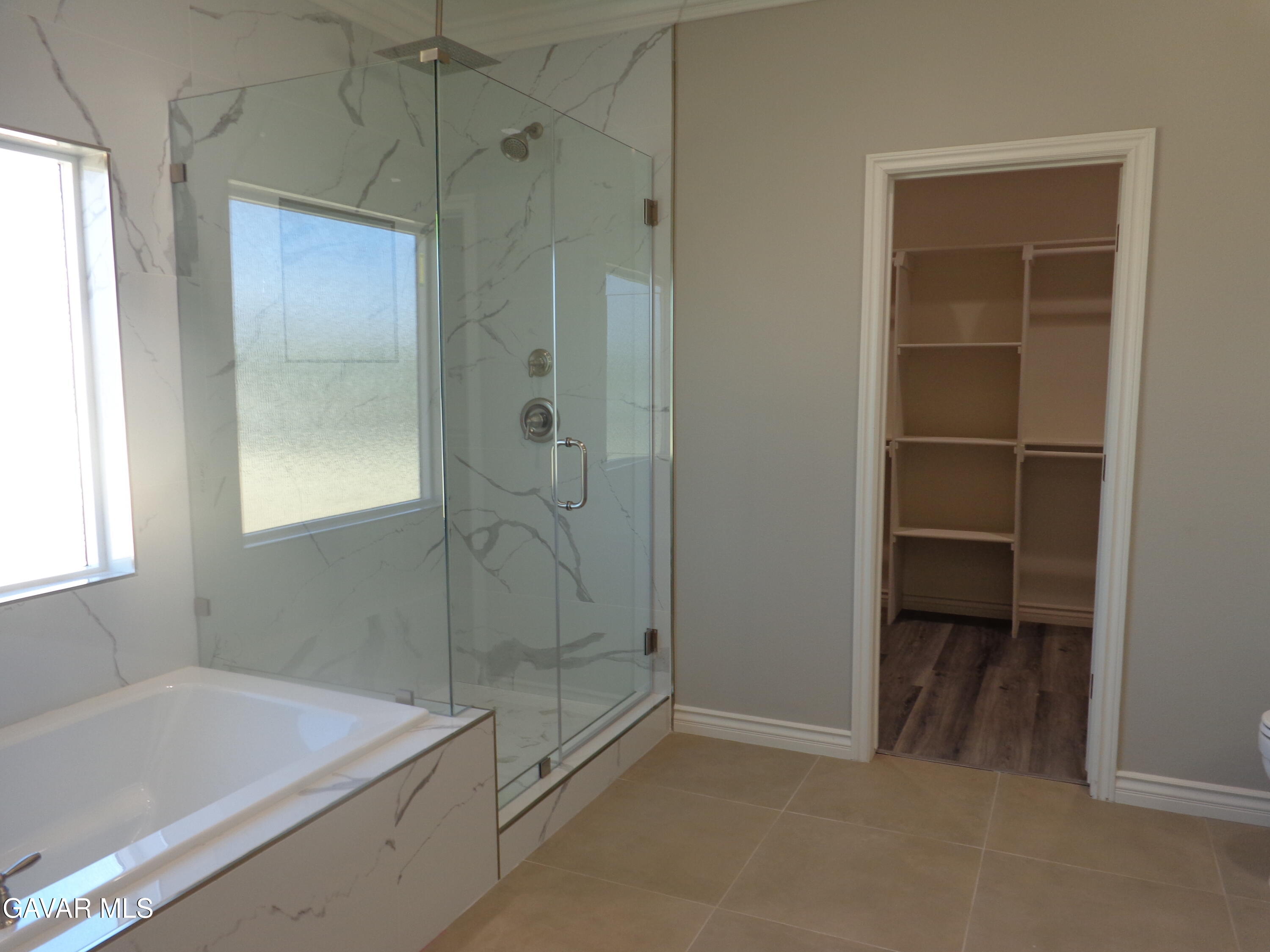 18255 Winnetka Road Apple Valley, CA 92307 - Photo 15 of 33 a bathroom with a shower and a bathtub