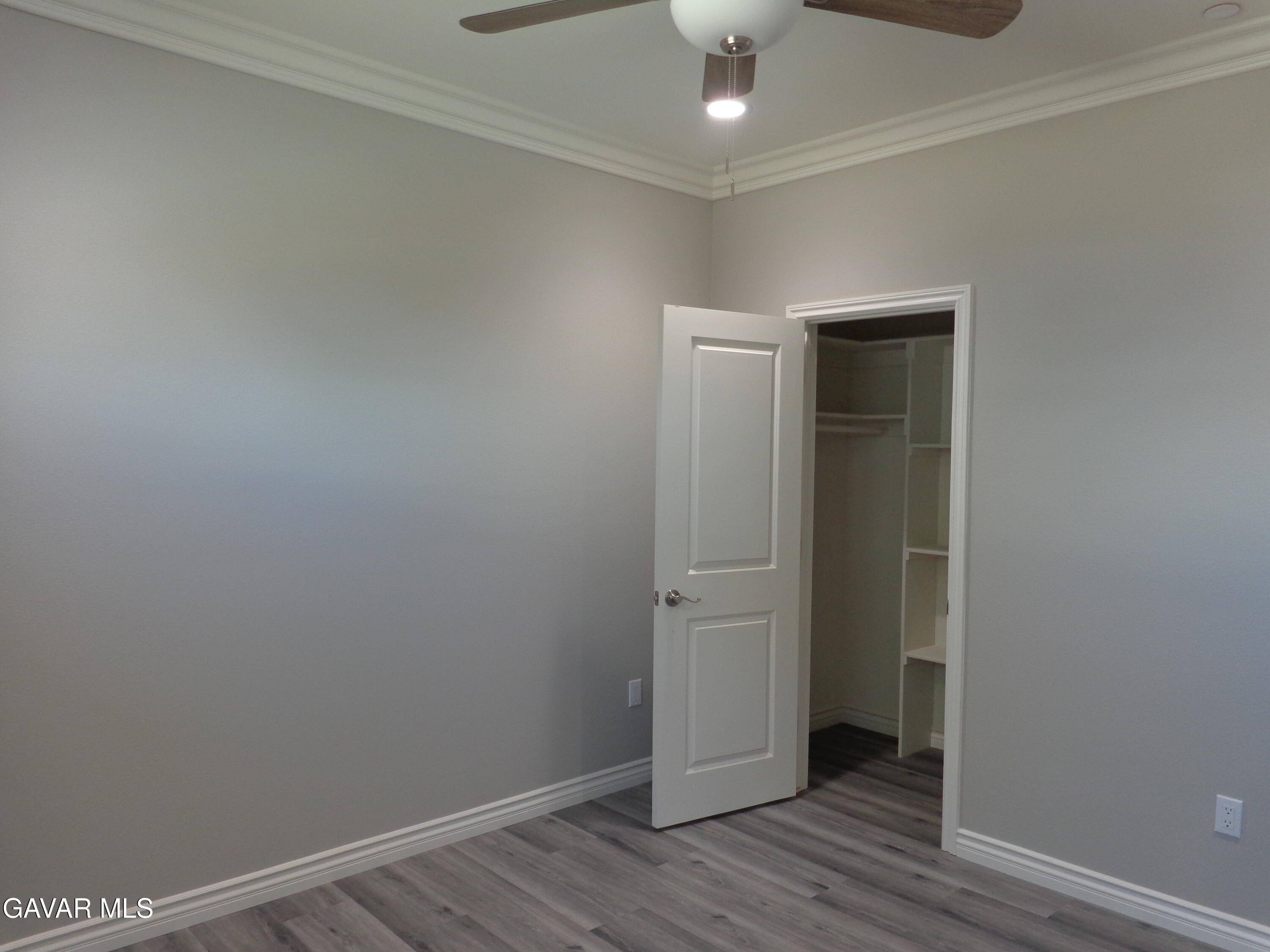 18255 Winnetka Road Apple Valley, CA 92307 - Photo 25 of 33 an empty room with wooden floor
