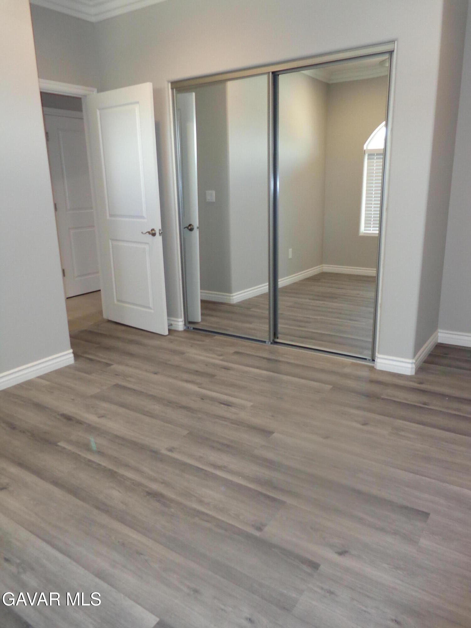 18255 Winnetka Road Apple Valley, CA 92307 - Photo 26 of 33 a view of empty room with wooden floor