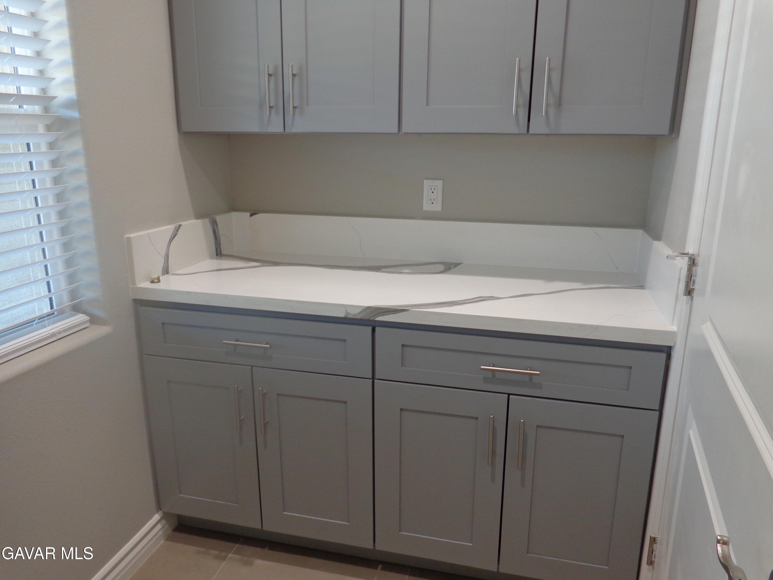 18255 Winnetka Road Apple Valley, CA 92307 - Photo 29 of 33 a utility room with cabinets