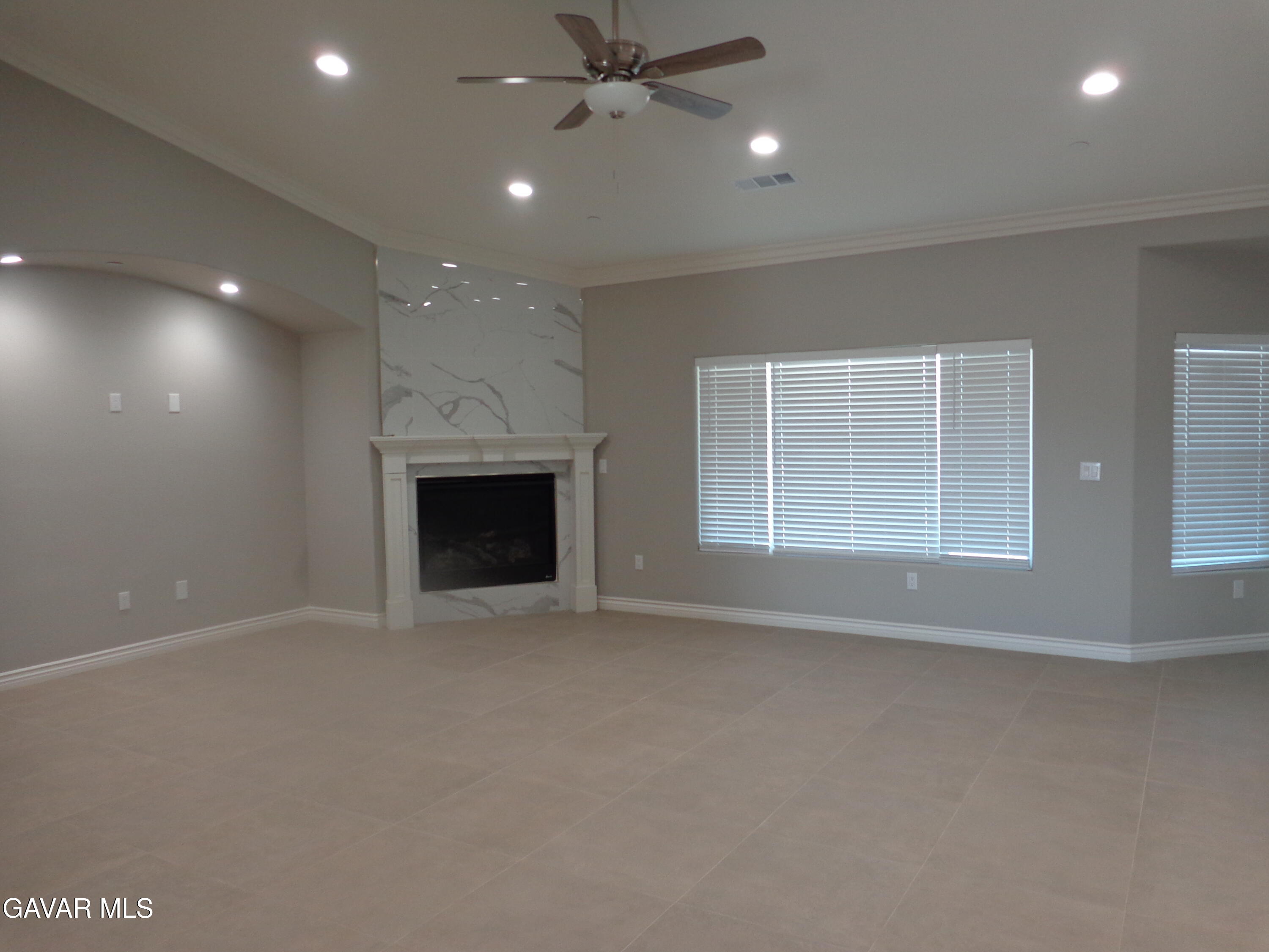 18255 Winnetka Road Apple Valley, CA 92307 - Photo 4 of 33 an empty room with windows and fireplace