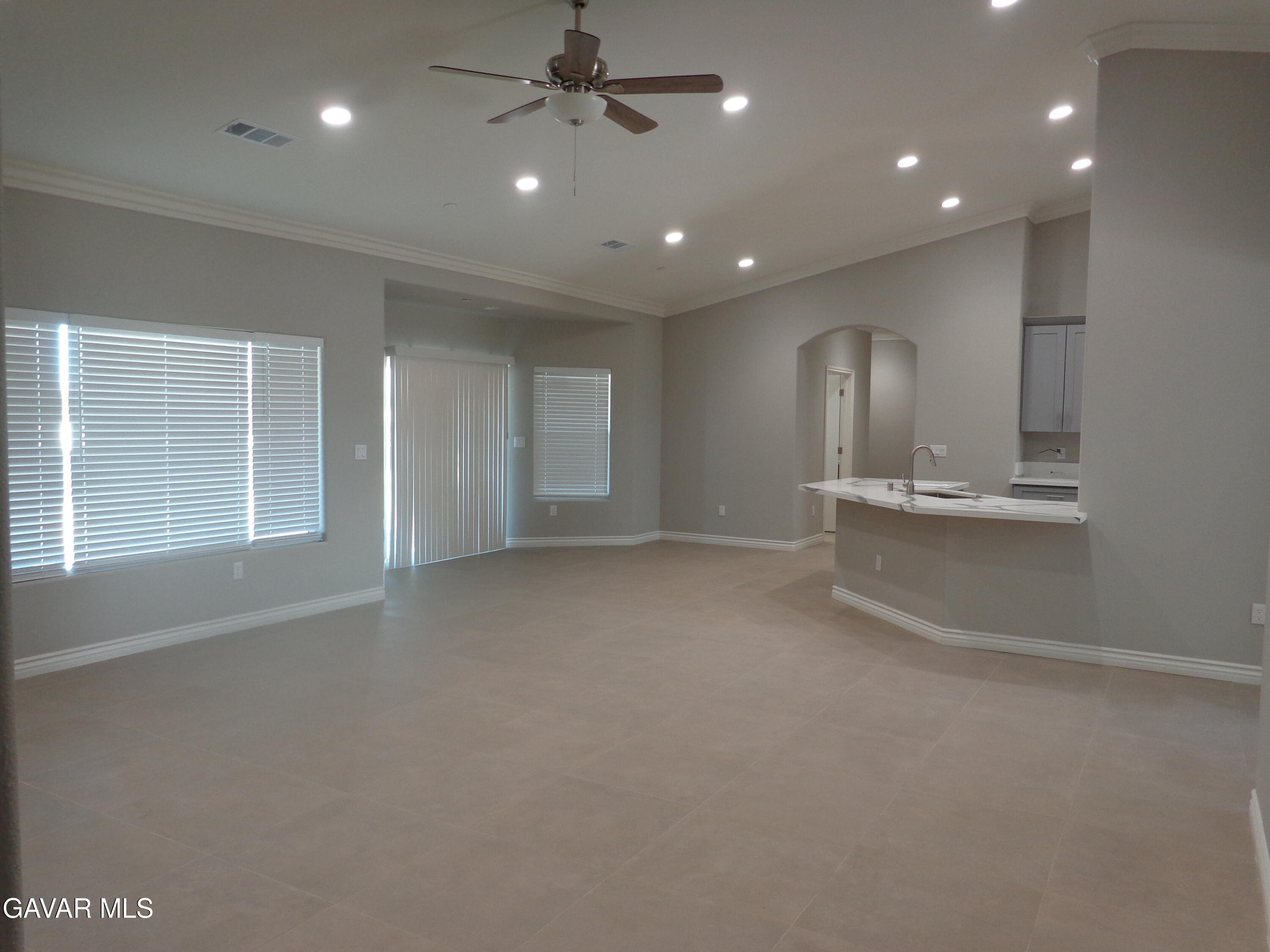 18255 Winnetka Road Apple Valley, CA 92307 - Photo 7 of 33 an empty room with wooden floor and windows