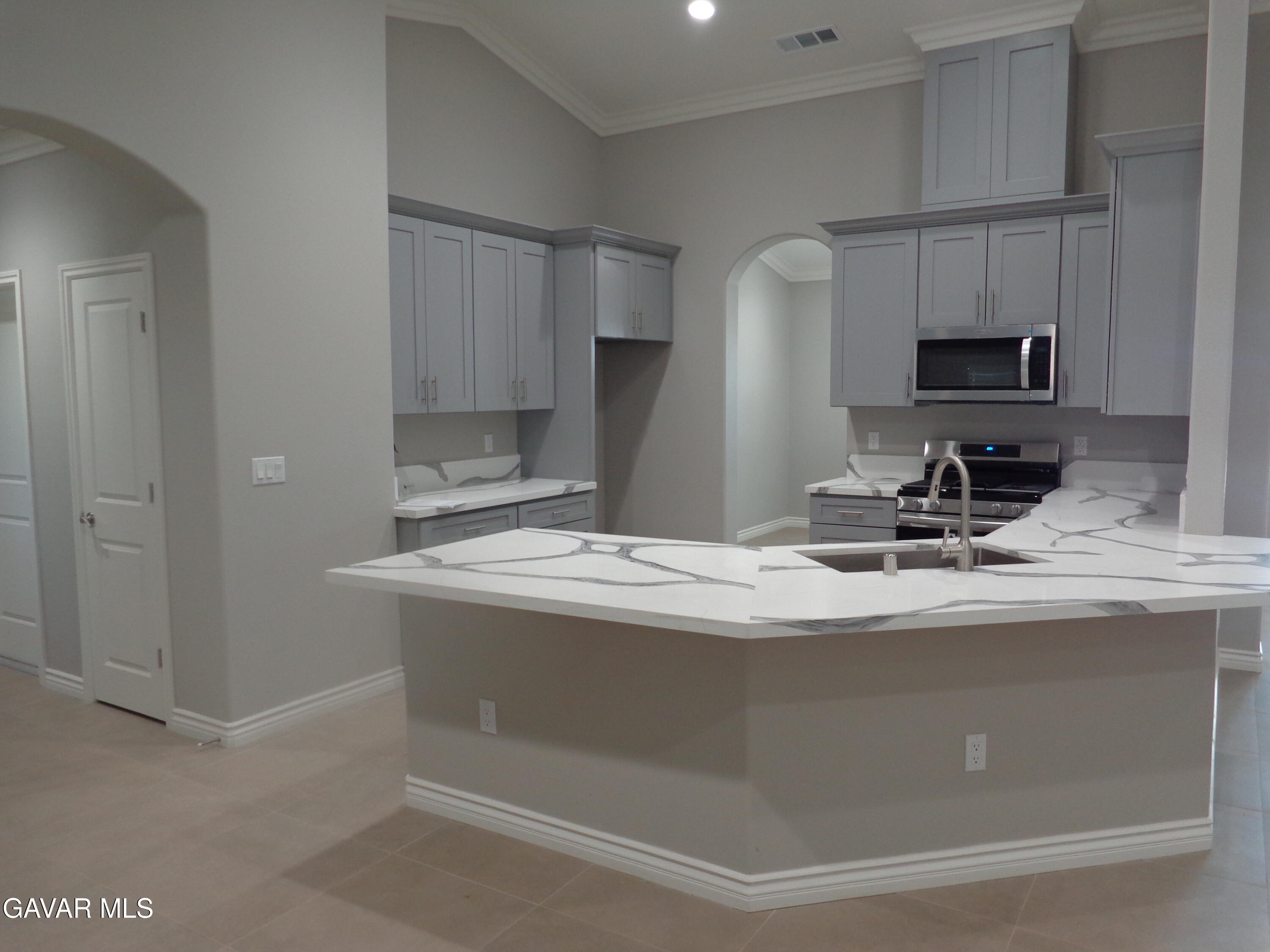 18255 Winnetka Road Apple Valley, CA 92307 - Photo 9 of 33 a kitchen with kitchen island sink stove and refrigerator