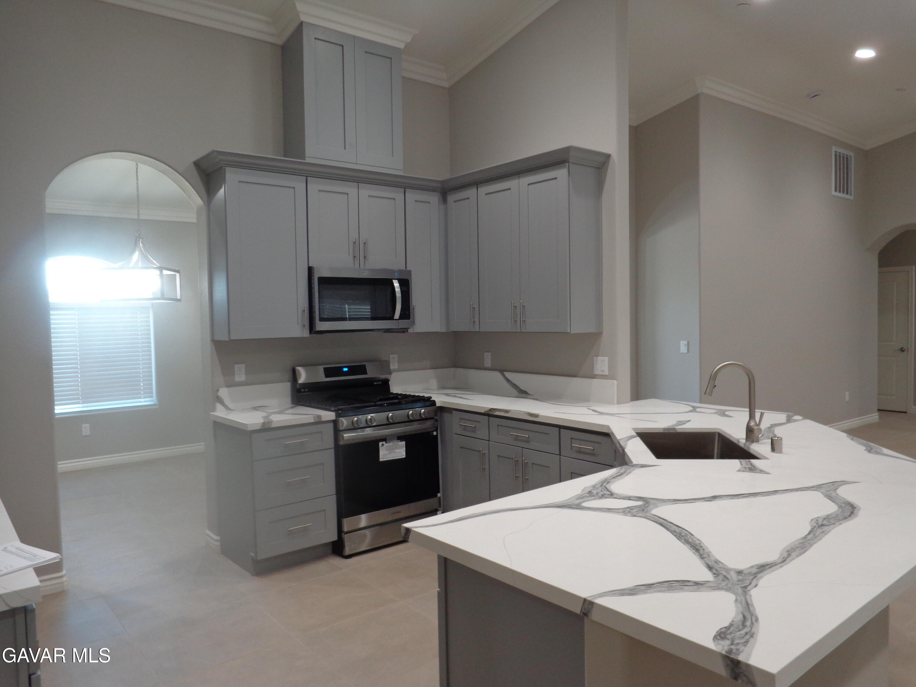 18255 Winnetka Road Apple Valley, CA 92307 - Photo 10 of 33 a kitchen that has a sink and a stove in it