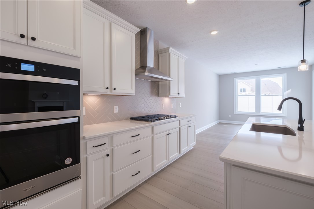 7951 Rogan Lane Painesville, OH 44077 - Photo 4 of 13 Built-in stainless steel appliances and plenty of storage in the white maple cabinetry