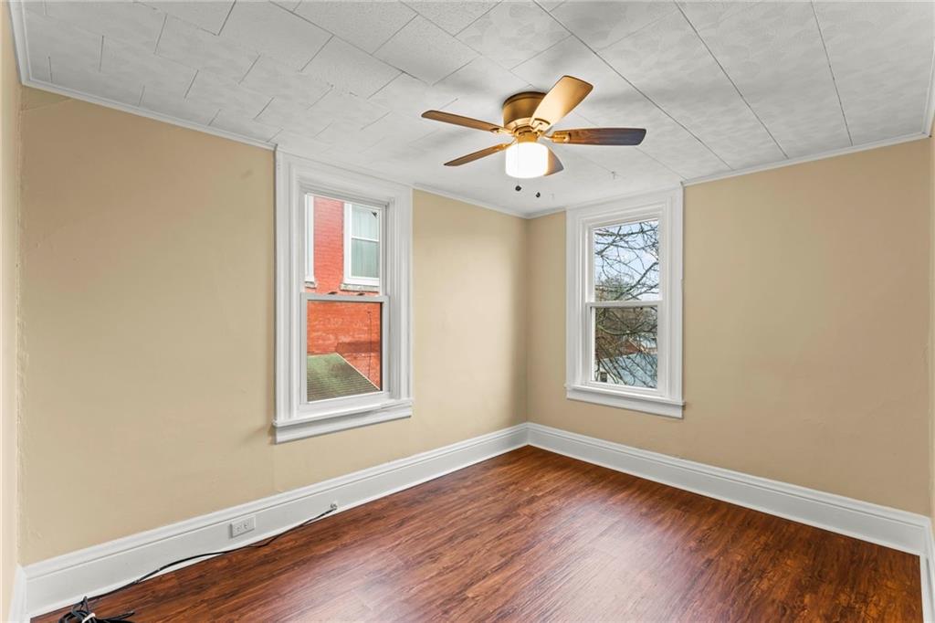 3350 Webster Avenue Pittsburgh, PA 15219 - Photo 14 of 23 a view of an empty room with wooden floor and window