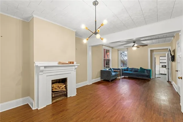 a view of empty room with wooden floor and fireplace