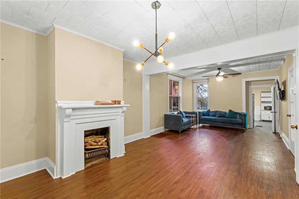 3350 Webster Avenue Pittsburgh, PA 15219 - Photo 6 of 23 a view of empty room with wooden floor and fireplace