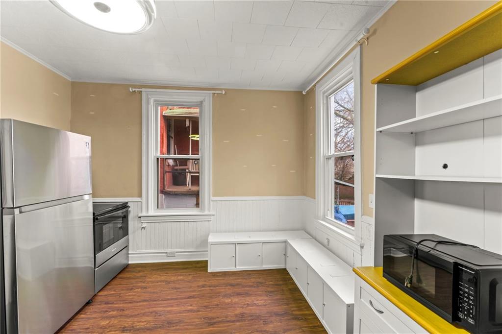 3350 Webster Avenue Pittsburgh, PA 15219 - Photo 8 of 23 a kitchen with a refrigerator and a stove top oven