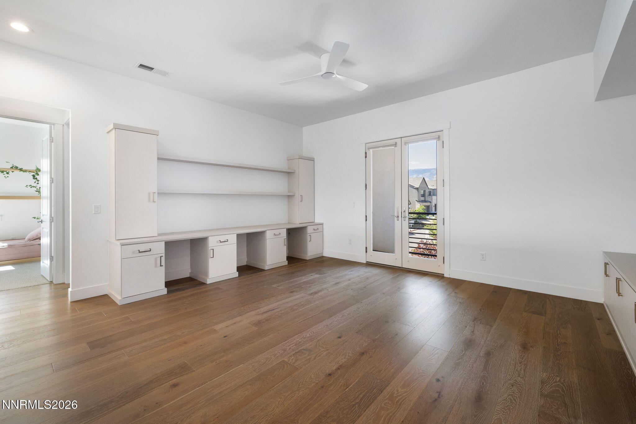5406 Side Saddle Trail Reno, NV 89511 - Photo 18 of 39 an empty room with wooden floor closet and windows