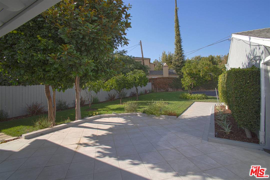 12101 Sunset Boulevard Los Angeles, CA 90049 - Photo 15 of 15 a backyard of a house with lots of green space