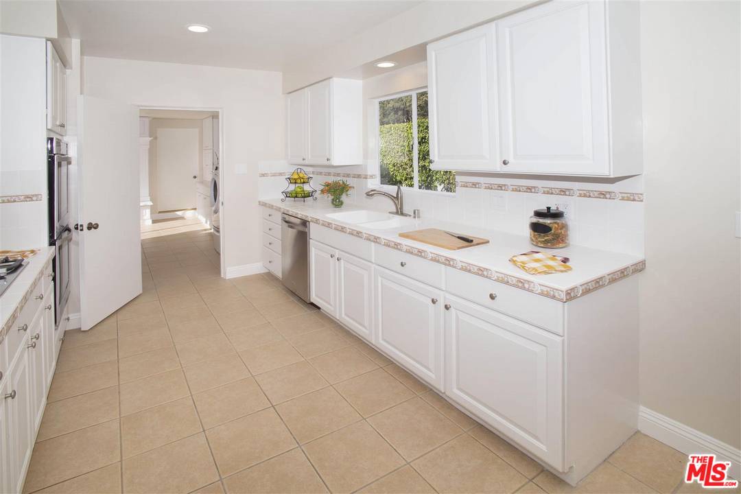 12101 Sunset Boulevard Los Angeles, CA 90049 - Photo 5 of 15 a kitchen with a sink stove and cabinets
