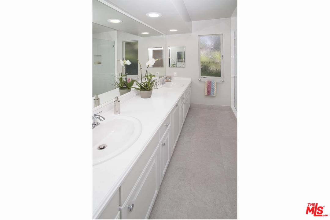 12101 Sunset Boulevard Los Angeles, CA 90049 - Photo 7 of 15 a bathroom with a sink and a mirror