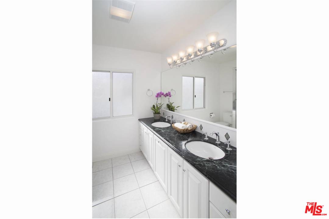 12101 Sunset Boulevard Los Angeles, CA 90049 - Photo 10 of 15 a kitchen with a sink and chandelier