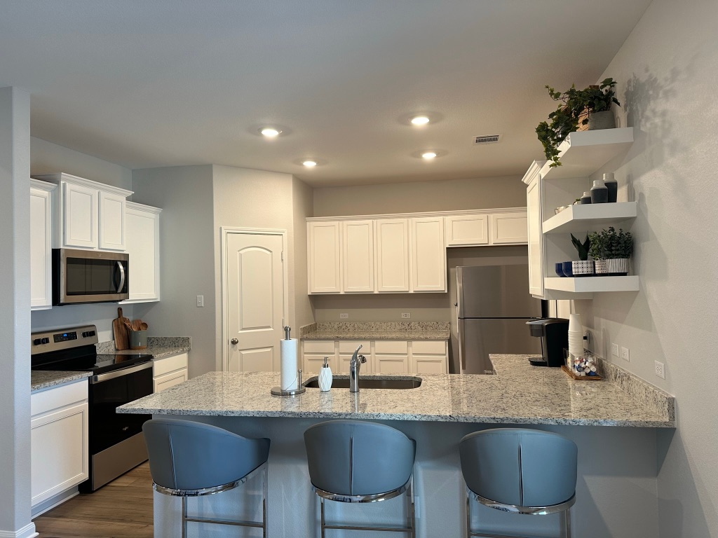 105 McLintock Road Jarrell, TX 76537 - Photo 9 of 10 Kitchen includes granite countertops, luxury vinyl plank flooring, 36” upper cabinets with crown molding, a full suite of stainless-steel Whirlpool appliances – including refrigerator with ice maker, recessed lighting, and a large single basin sink.
Pictures, floor plans, features, and colors are approximate for illustration purposes only. Home pictured may display decorative items, furniture and enhanced interior paint which are not available for purchase even upon additional payment.
