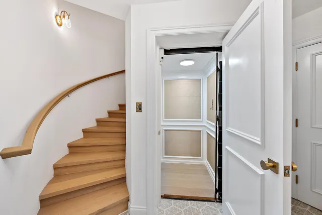 a view of staircase with white walls and railing
