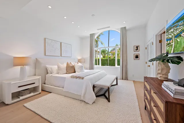 a bed room with a bed and a chair