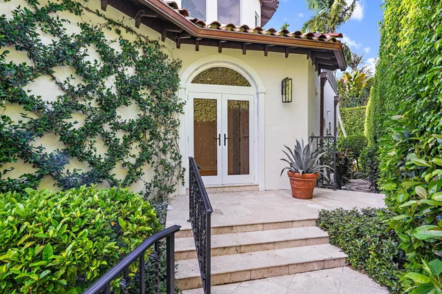 a front view of a house with a garden