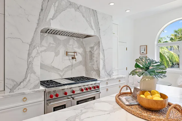 a stove top oven sitting inside of a kitchen