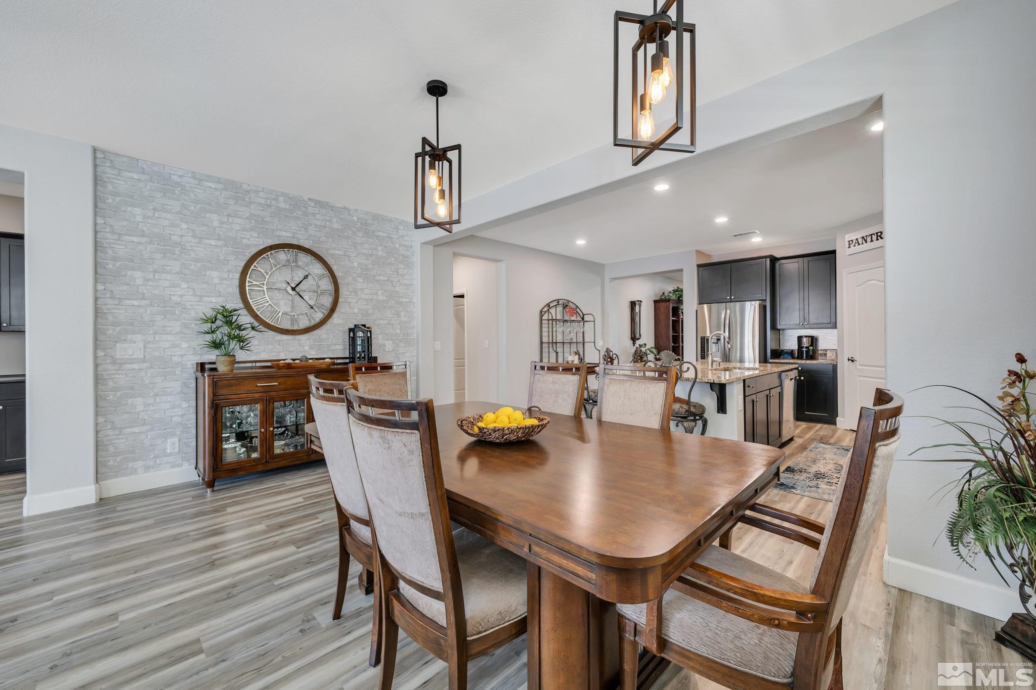 10128 Quintana Drive Reno, NV 89521 - Photo 12 of 34 a view of a dining room with furniture and wooden floor