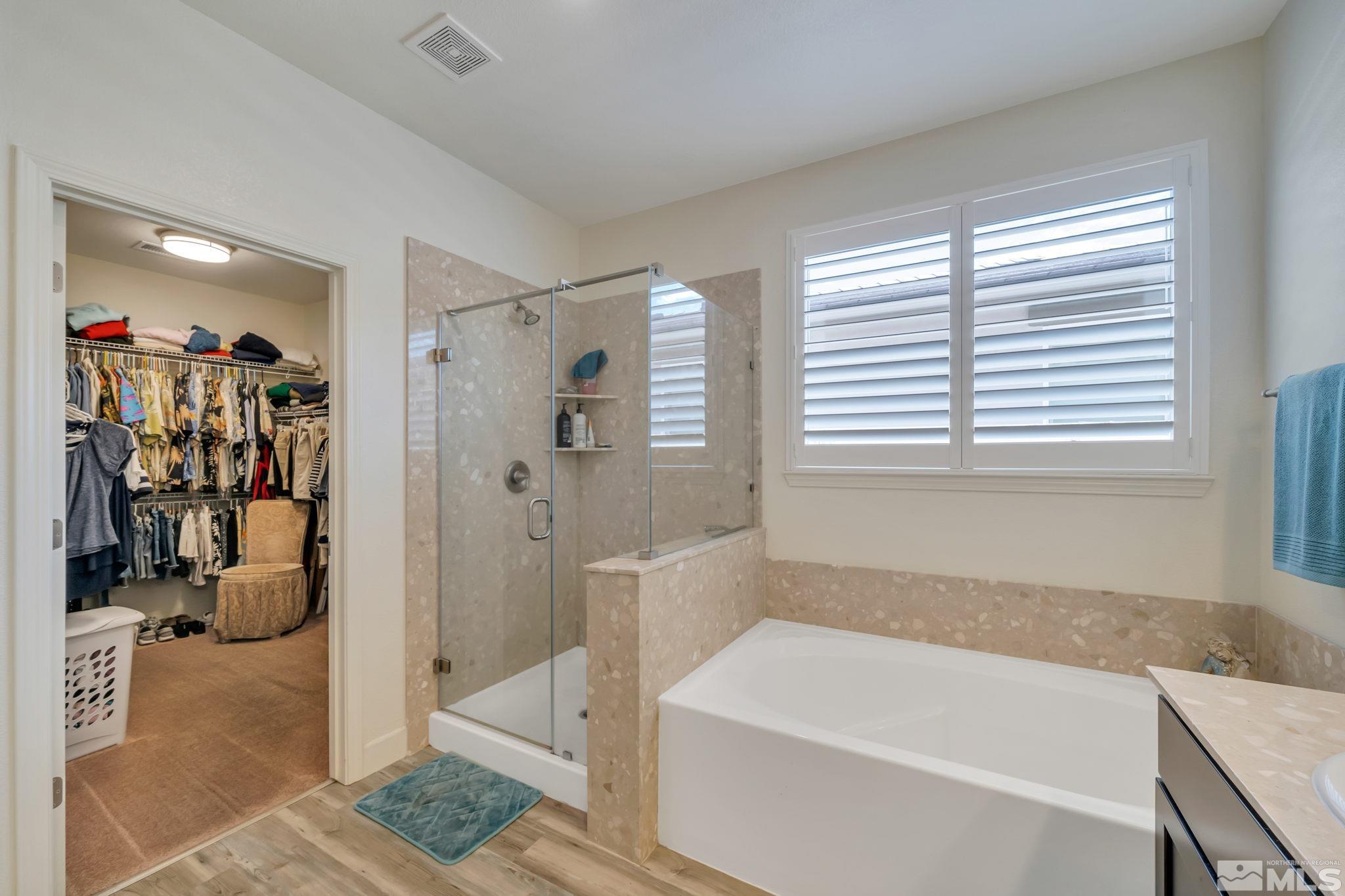 10128 Quintana Drive Reno, NV 89521 - Photo 19 of 34 a bathroom with a tub a sink and a shower