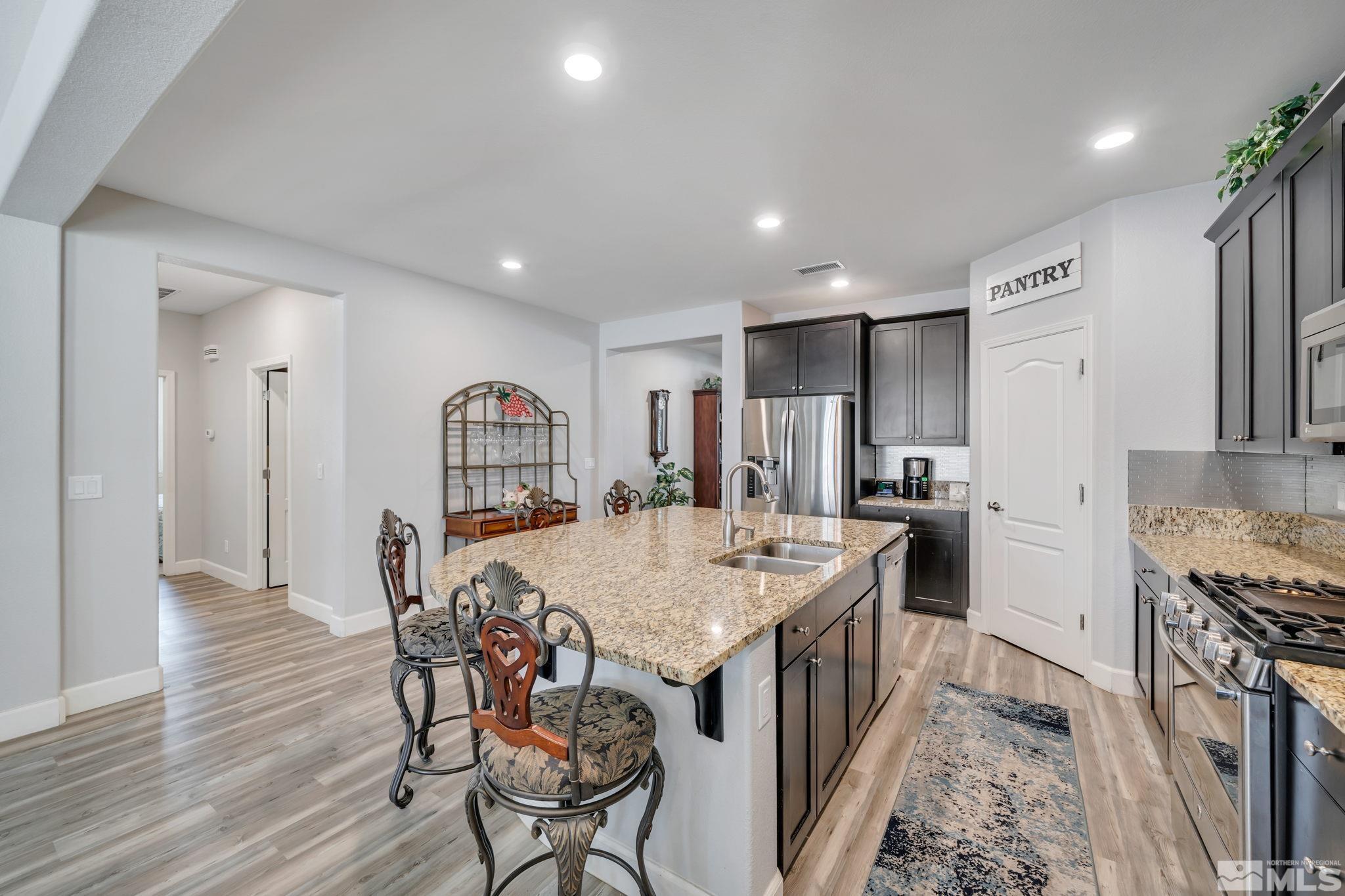 10128 Quintana Drive Reno, NV 89521 - Photo 9 of 34 a kitchen with a table and chairs in it