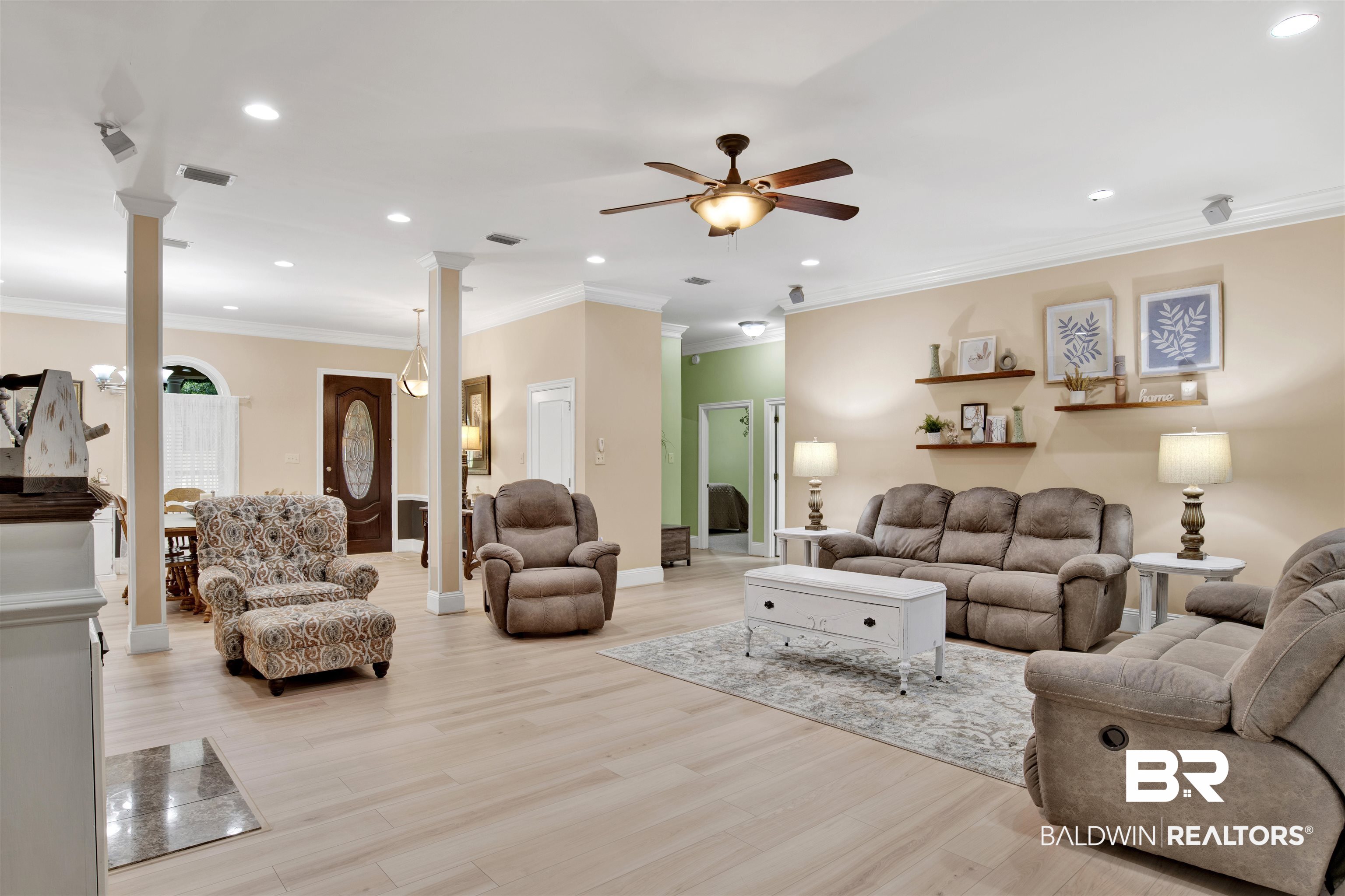 4340 Hamilton Oaks Lane Mobile, AL 36695 - Photo 11 of 51 Living room featuring ceiling fan, crown molding, and decorative columns