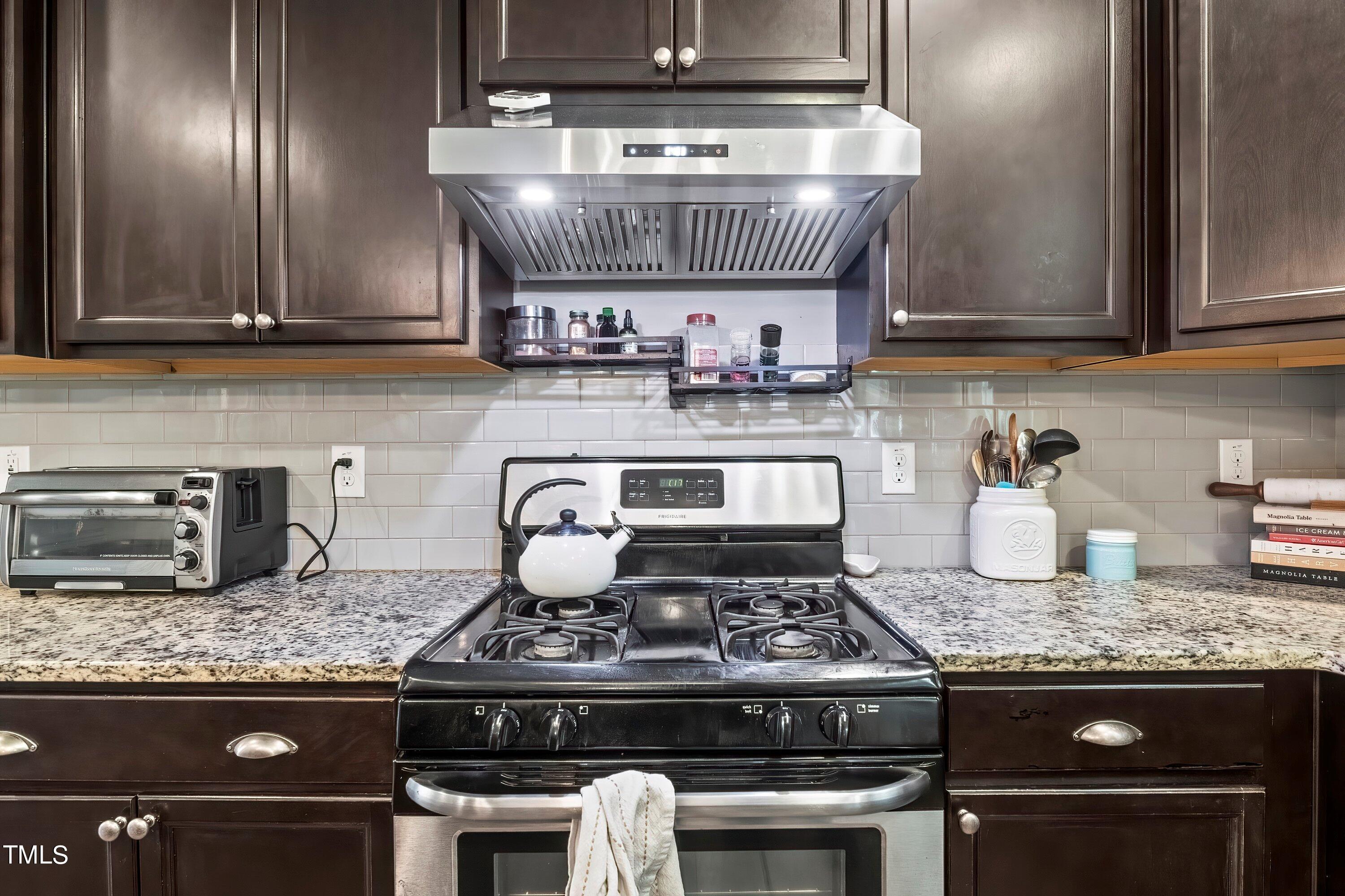 7406 Randshire Way Raleigh, NC 27616 - Photo 14 of 38 a stove top oven sitting inside of a kitchen