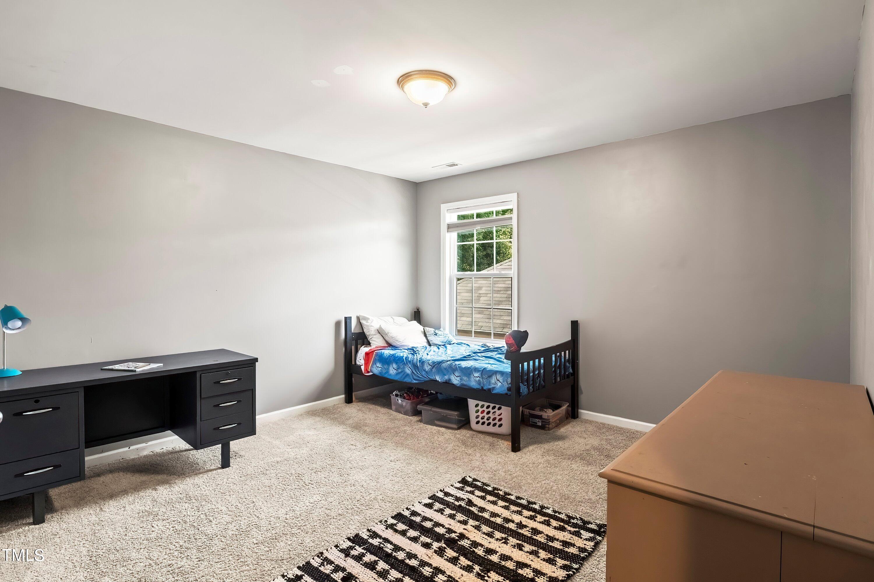 7406 Randshire Way Raleigh, NC 27616 - Photo 20 of 38 a bedroom with furniture and a window