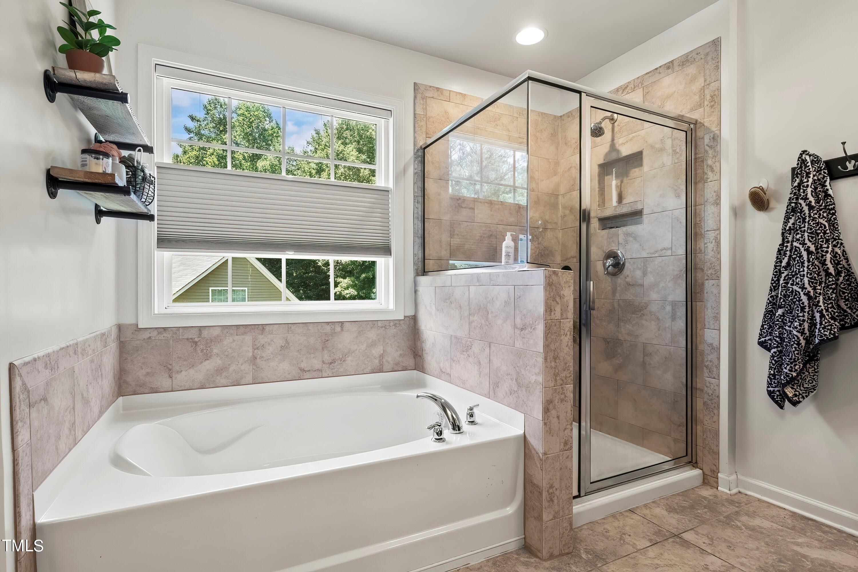 7406 Randshire Way Raleigh, NC 27616 - Photo 26 of 38 a bathroom with a bathtub and a shower