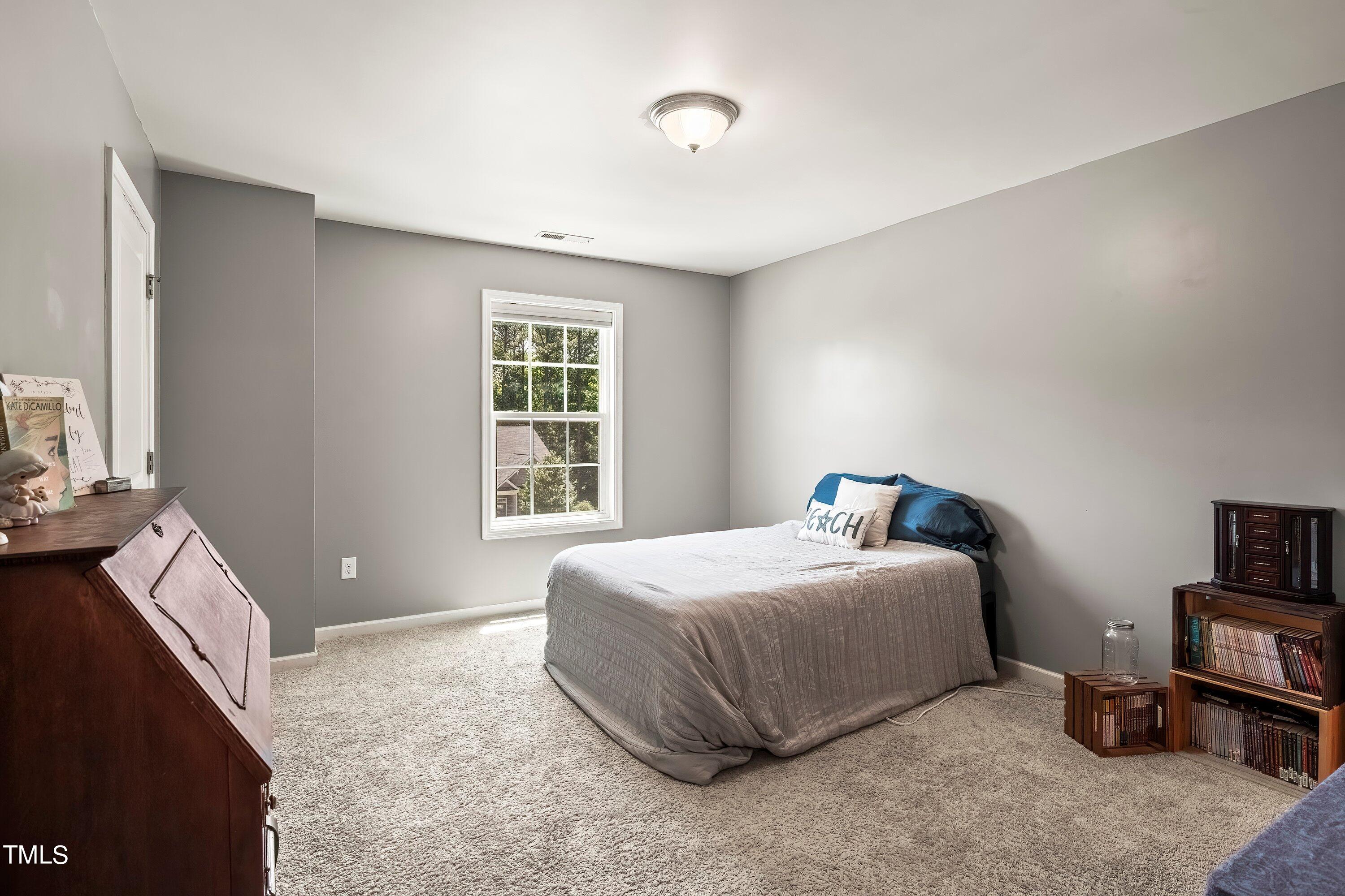 7406 Randshire Way Raleigh, NC 27616 - Photo 29 of 38 a bedroom with a bed and a window