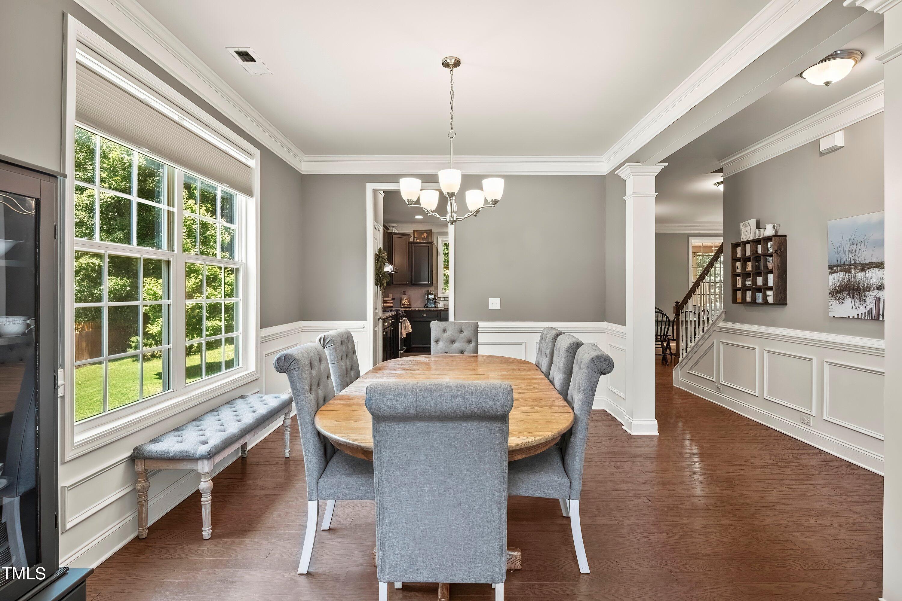 7406 Randshire Way Raleigh, NC 27616 - Photo 5 of 38 a dining room with furniture a window and wooden floor