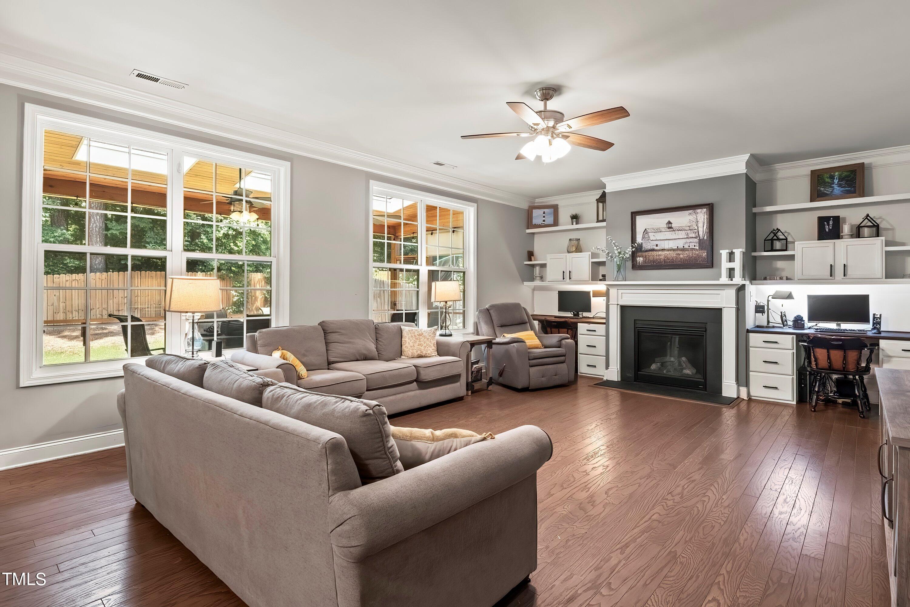 7406 Randshire Way Raleigh, NC 27616 - Photo 6 of 38 a living room with furniture large window and fireplace