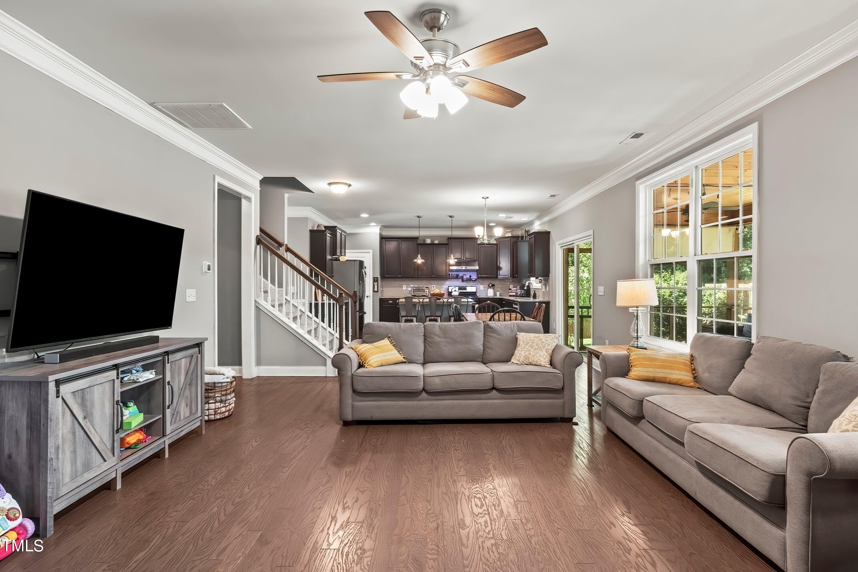 7406 Randshire Way Raleigh, NC 27616 - Photo 9 of 38 a living room with furniture and a flat screen tv