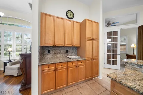 a kitchen with stainless steel appliances granite countertop a refrigerator sink and cabinets