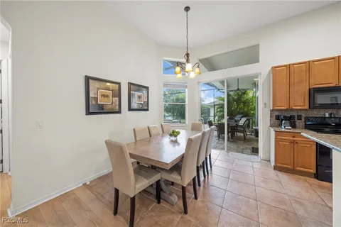 a dining room with furniture a chandelier and window
