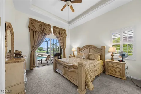 a bedroom with a bed next to a large window with the outer view