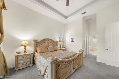 a spacious bedroom with a bed and a dresser