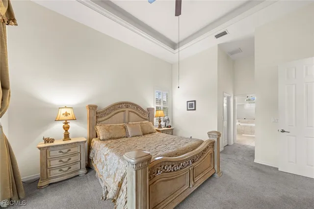 a spacious bedroom with a bed and a dresser