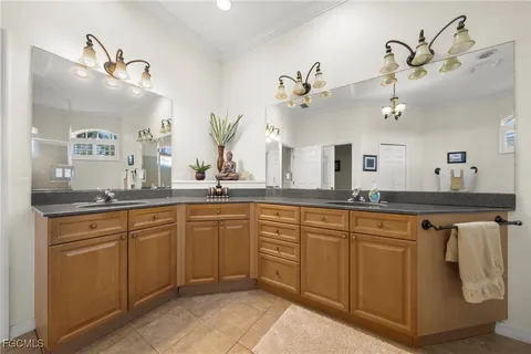 a spacious bathroom with a granite countertop sink a mirror and vanity
