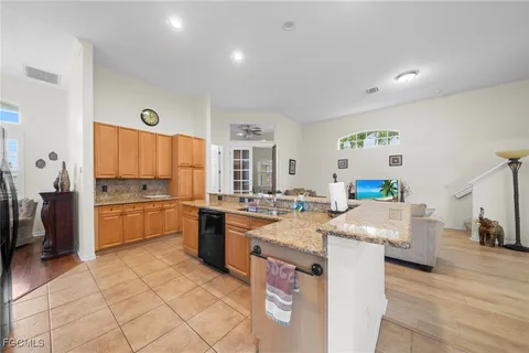 a open kitchen with stainless steel appliances granite countertop a stove oven and a refrigerator