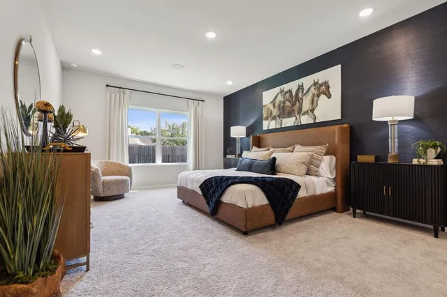 a spacious bedroom with a bed and a couch