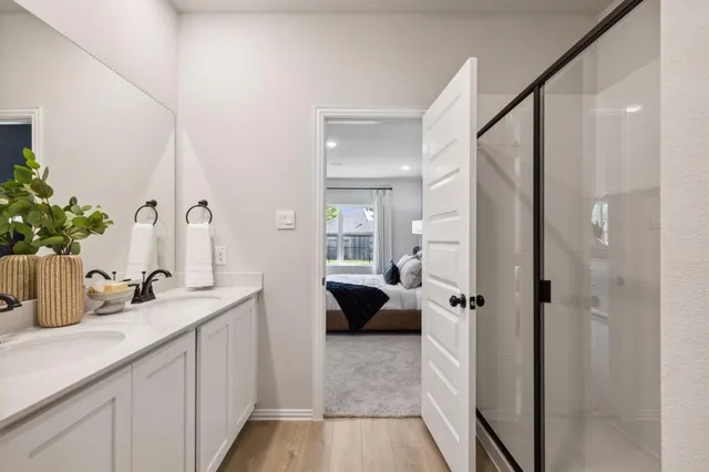 a en suite bathroom with a sink a mirror and a shower