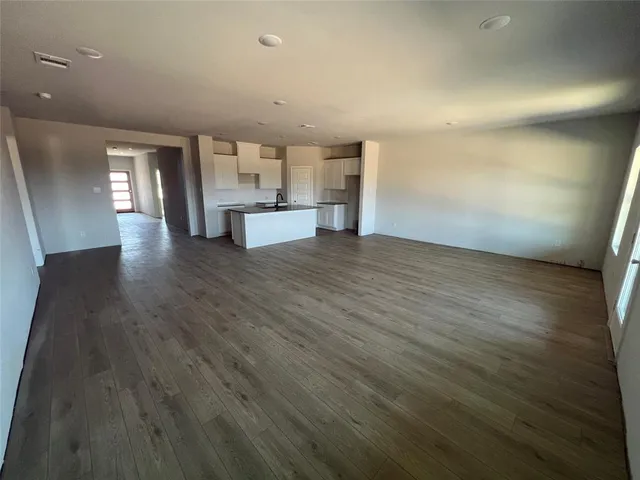 a view of a kitchen with wooden floor and a sink