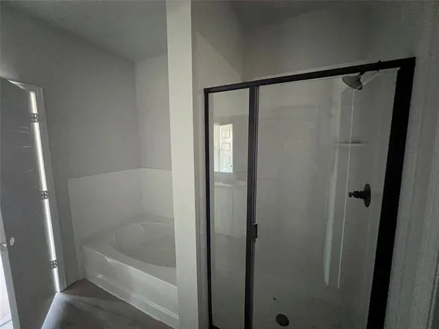 a bathroom with a glass shower door
